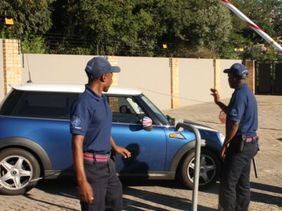 Guards ensuring clients drive out safely